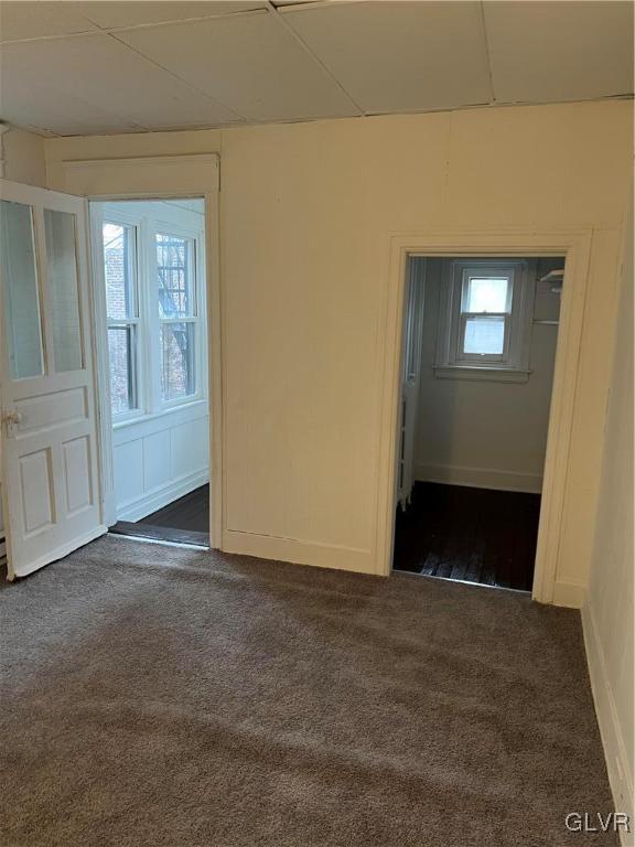 empty room with dark carpet