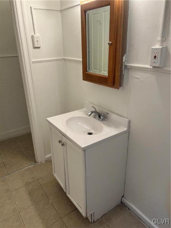 bathroom featuring tile patterned flooring and vanity