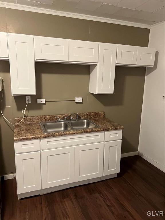 kitchen with white cabinets, sink, and dark wood-type flooring