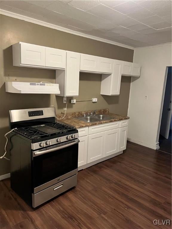 kitchen with white cabinets, sink, stainless steel gas range oven, range hood, and dark hardwood / wood-style flooring