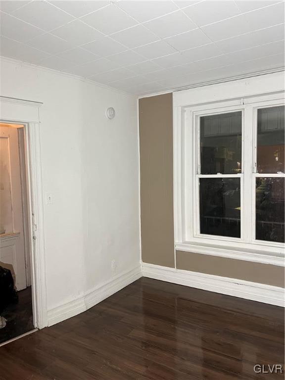 empty room with dark wood-type flooring