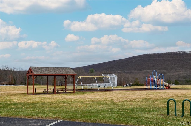 view of playground with a yard and a gazebo