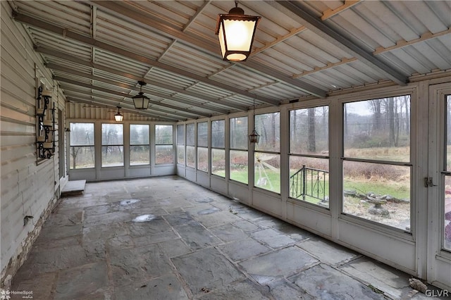 unfurnished sunroom with lofted ceiling