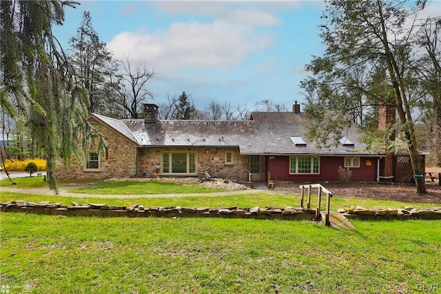 rear view of house featuring a lawn