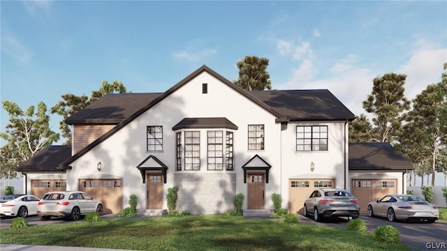 view of front of home featuring a garage, stucco siding, and a front lawn