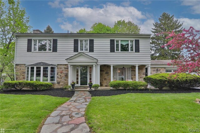 colonial inspired home with a front yard