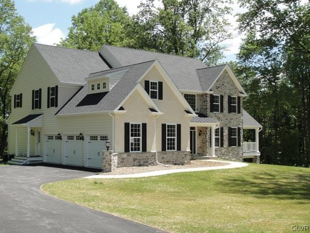 2059 Sunrise Dr Lot 7, Springfield Twp, PA 18036 - view of front facade with stone siding, a front yard, asphalt driveway, and a shingled roof