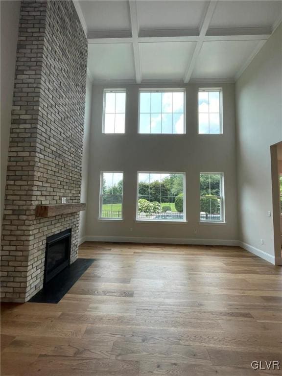 2059 Sunrise Dr Lot 7, Springfield Twp, PA 18036 - unfurnished living room with coffered ceiling, a high ceiling, wood finished floors, plenty of natural light, and baseboards