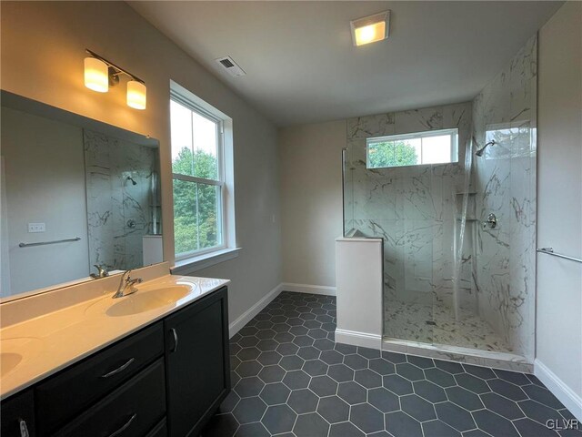 bathroom featuring tiled shower and vanity