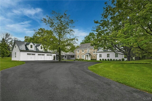 view of front of property featuring a garage and a front lawn