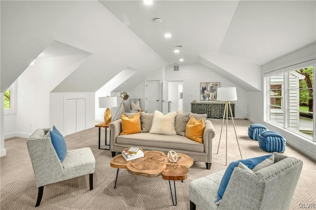 carpeted living room featuring lofted ceiling