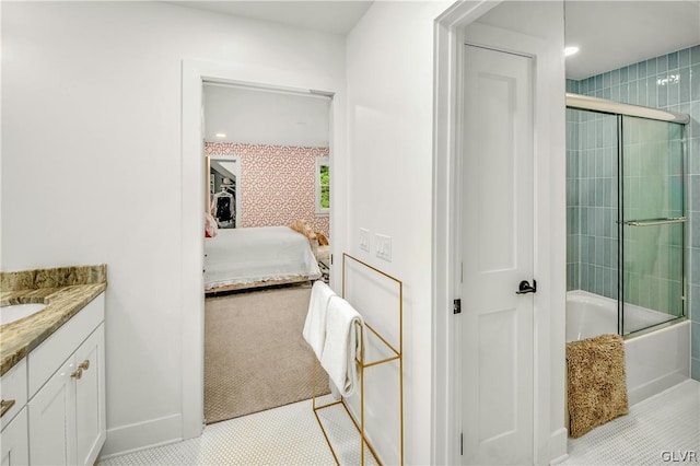 bathroom featuring tile patterned floors, combined bath / shower with glass door, and vanity