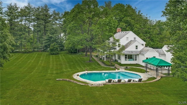 view of swimming pool with a gazebo and a lawn