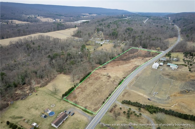 birds eye view of property with a rural view