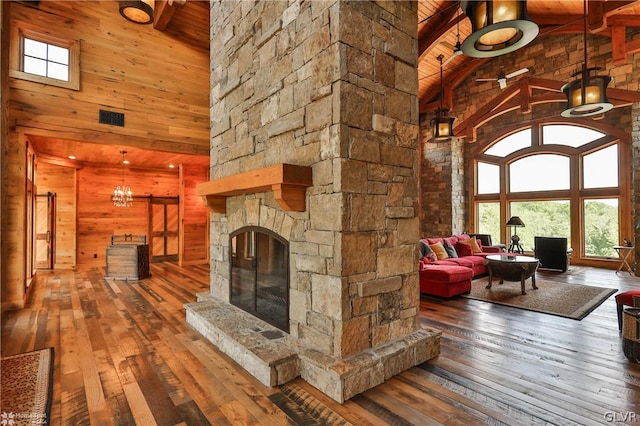 unfurnished living room with dark hardwood / wood-style flooring, high vaulted ceiling, and beam ceiling