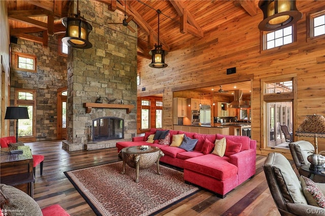 living room with wood walls, ceiling fan, high vaulted ceiling, and hardwood / wood-style flooring