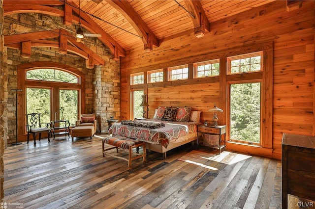 bedroom with beamed ceiling, high vaulted ceiling, wood-type flooring, and multiple windows