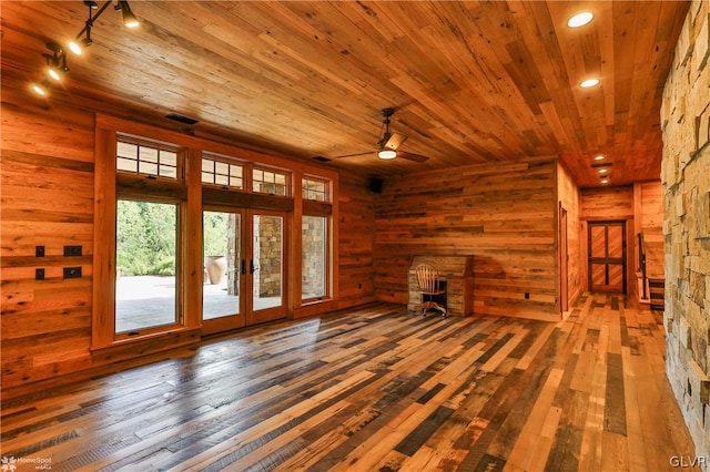 unfurnished living room featuring ceiling fan, wood ceiling, french doors, hardwood / wood-style flooring, and rail lighting