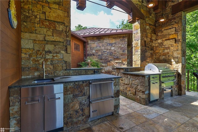 view of patio featuring sink, exterior kitchen, and area for grilling