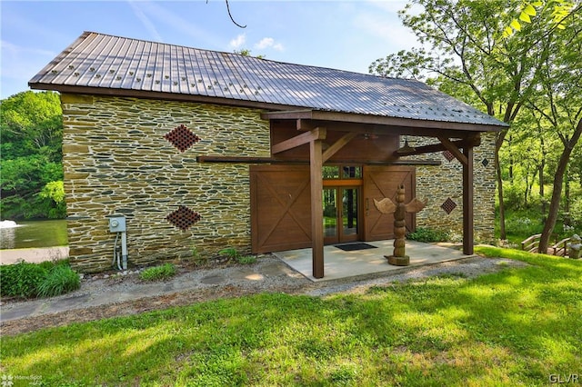 rear view of house featuring a patio and a yard