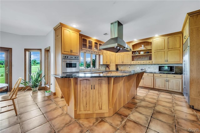 kitchen featuring stainless steel appliances, island exhaust hood, decorative backsplash, and open shelves