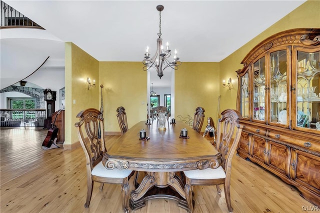 dining area with an inviting chandelier, light wood-style flooring, and plenty of natural light