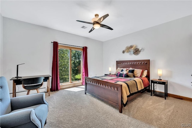 carpeted bedroom with a baseboard heating unit, ceiling fan, visible vents, and baseboards