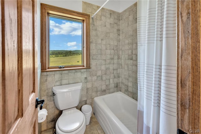 full bathroom featuring shower / tub combo with curtain, tile walls, toilet, and tile patterned floors