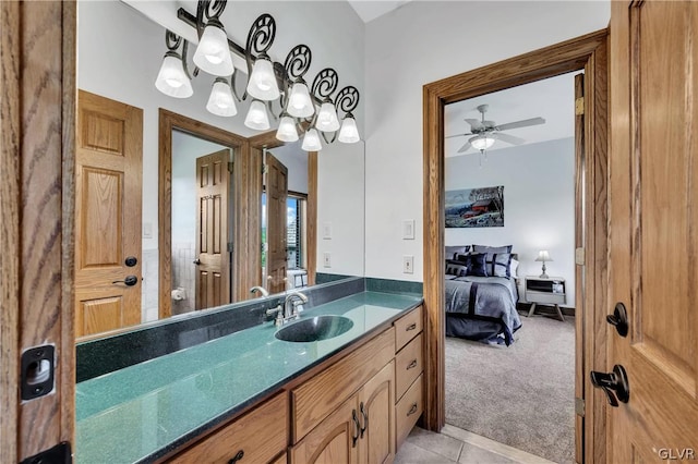 ensuite bathroom featuring ceiling fan, vanity, ensuite bath, and tile patterned floors