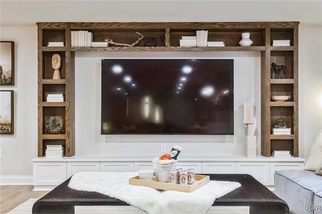 interior details with built in shelves and wood-type flooring