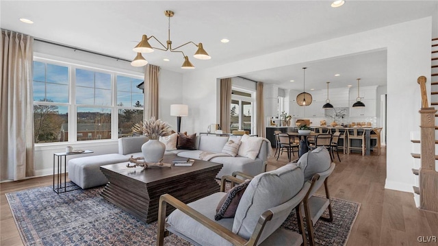 living room featuring wood-type flooring and a chandelier