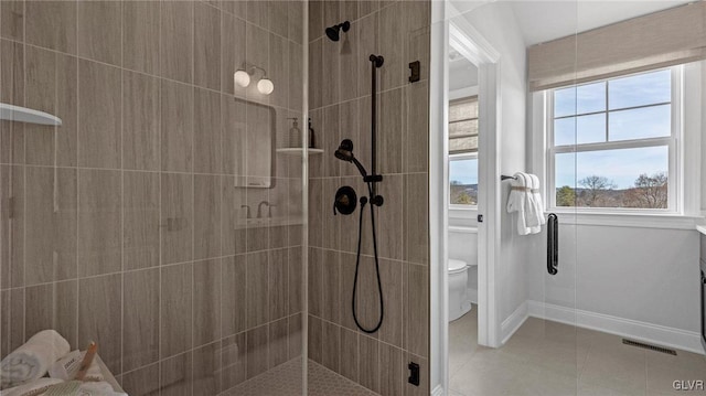 bathroom with walk in shower and toilet