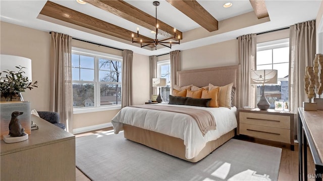 bedroom featuring light hardwood / wood-style flooring, an inviting chandelier, and multiple windows