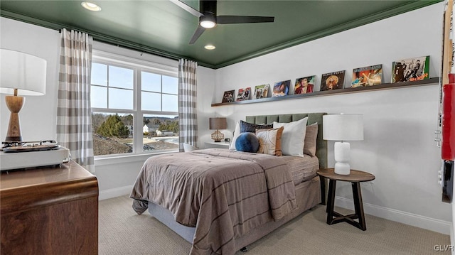 bedroom featuring ceiling fan, ornamental molding, and light carpet