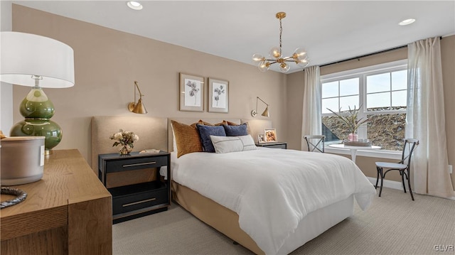 carpeted bedroom with an inviting chandelier