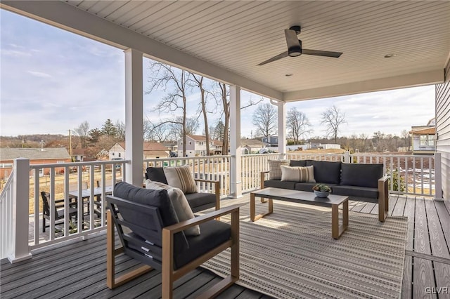 wooden terrace with ceiling fan and outdoor lounge area