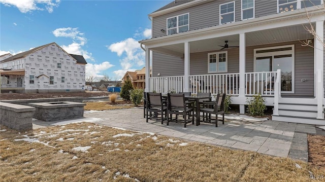 view of patio featuring ceiling fan and an outdoor fire pit