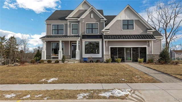 craftsman inspired home with a front yard and covered porch