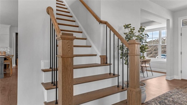 staircase featuring wood-type flooring