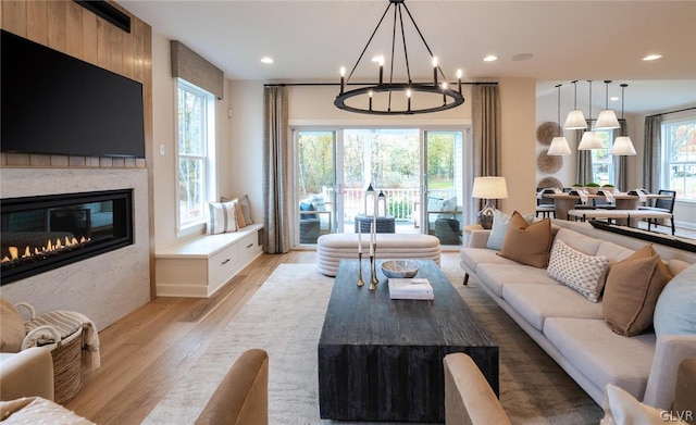 living room featuring light hardwood / wood-style floors and a chandelier