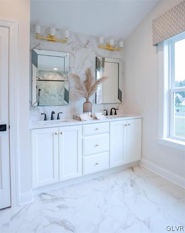 bathroom with dual vanity, tile patterned flooring, tasteful backsplash, and vaulted ceiling