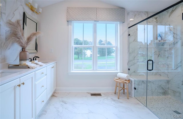 bathroom featuring a shower with shower door, tile patterned flooring, and dual bowl vanity