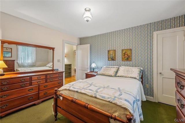 carpeted bedroom featuring baseboards and wallpapered walls