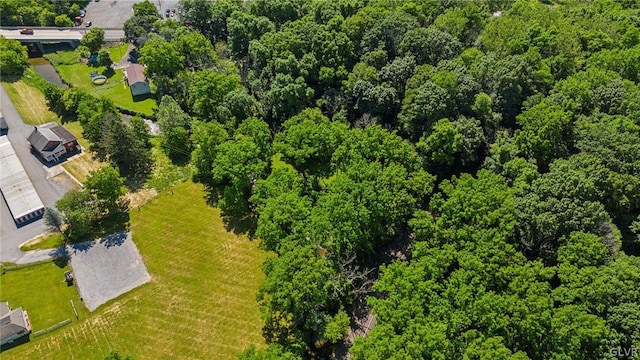 birds eye view of property with a wooded view