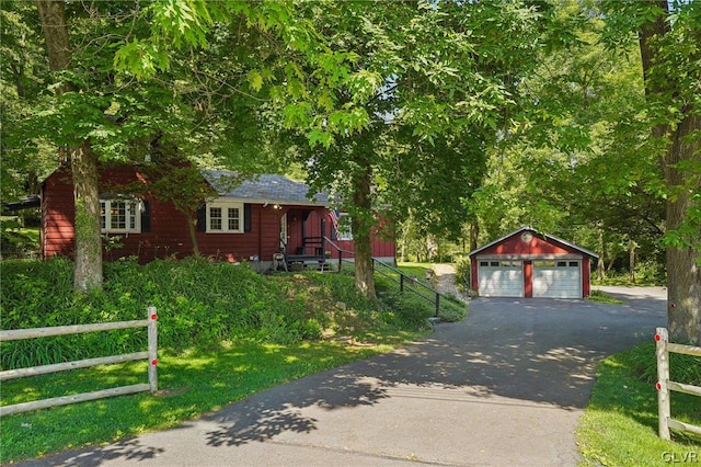 view of front of property with a garage and an outbuilding