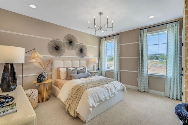 carpeted bedroom with multiple windows and a chandelier