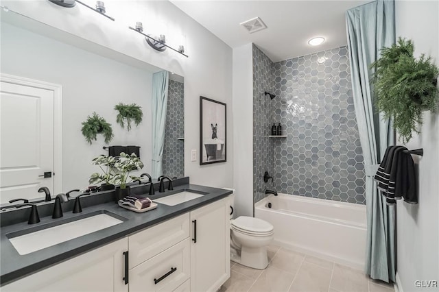 full bathroom featuring dual vanity, toilet, shower / bath combo, and tile patterned flooring