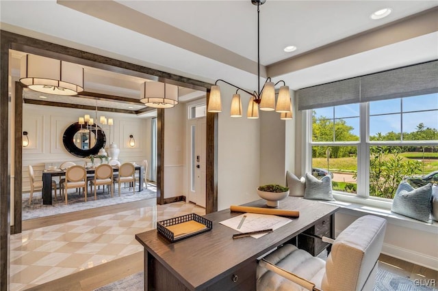 home office featuring an inviting chandelier and a raised ceiling