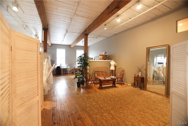 sitting room featuring vaulted ceiling with beams, wooden ceiling, and hardwood / wood-style floors