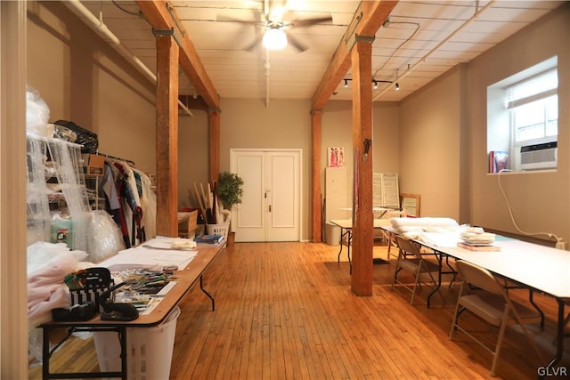 home office featuring ceiling fan, cooling unit, and light wood-type flooring